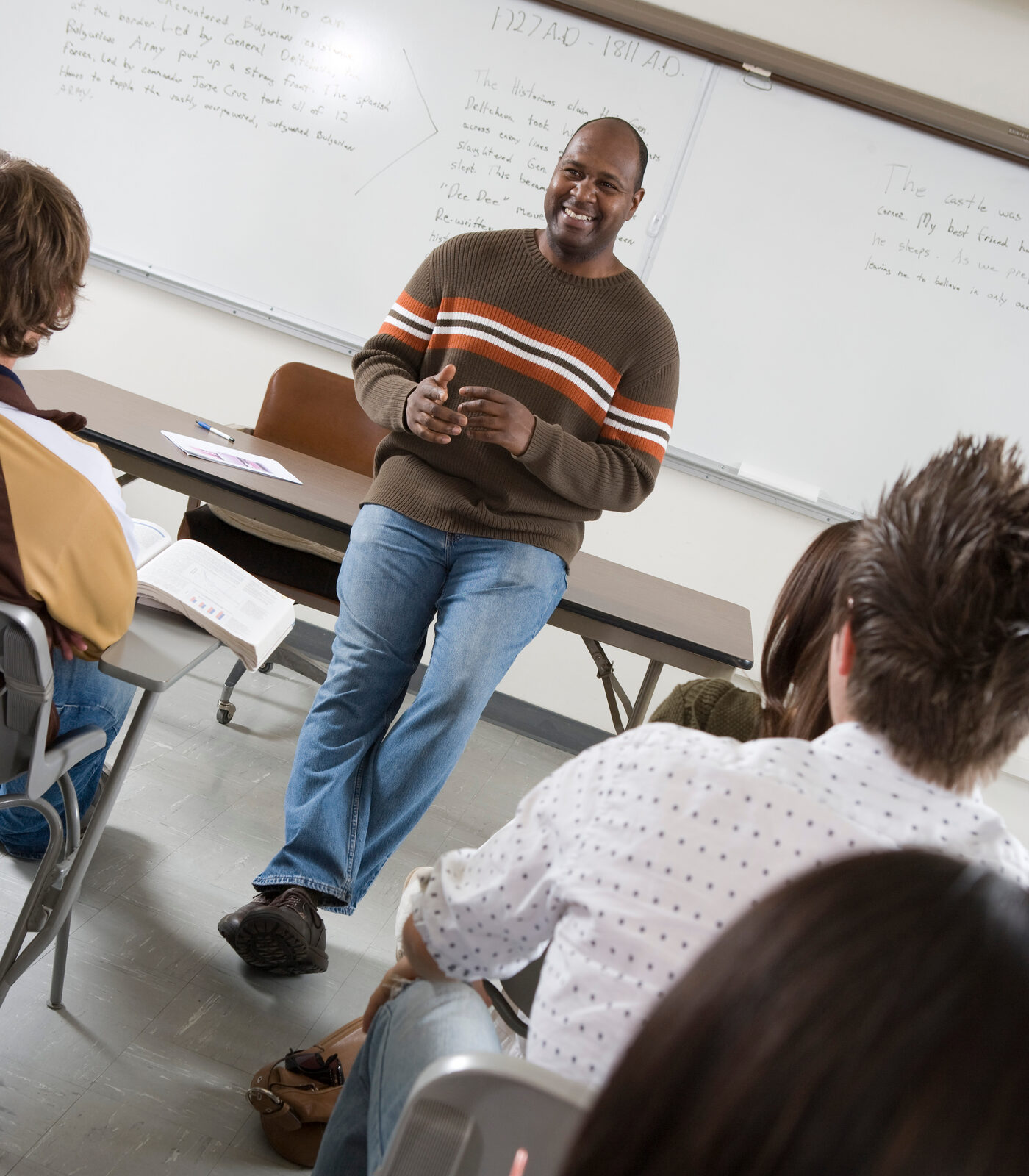 A teacher talking with a classroom of adult students