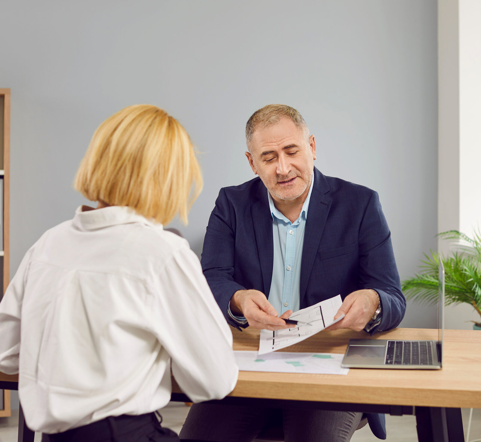 Advisor reviewing a document with a client across a desk